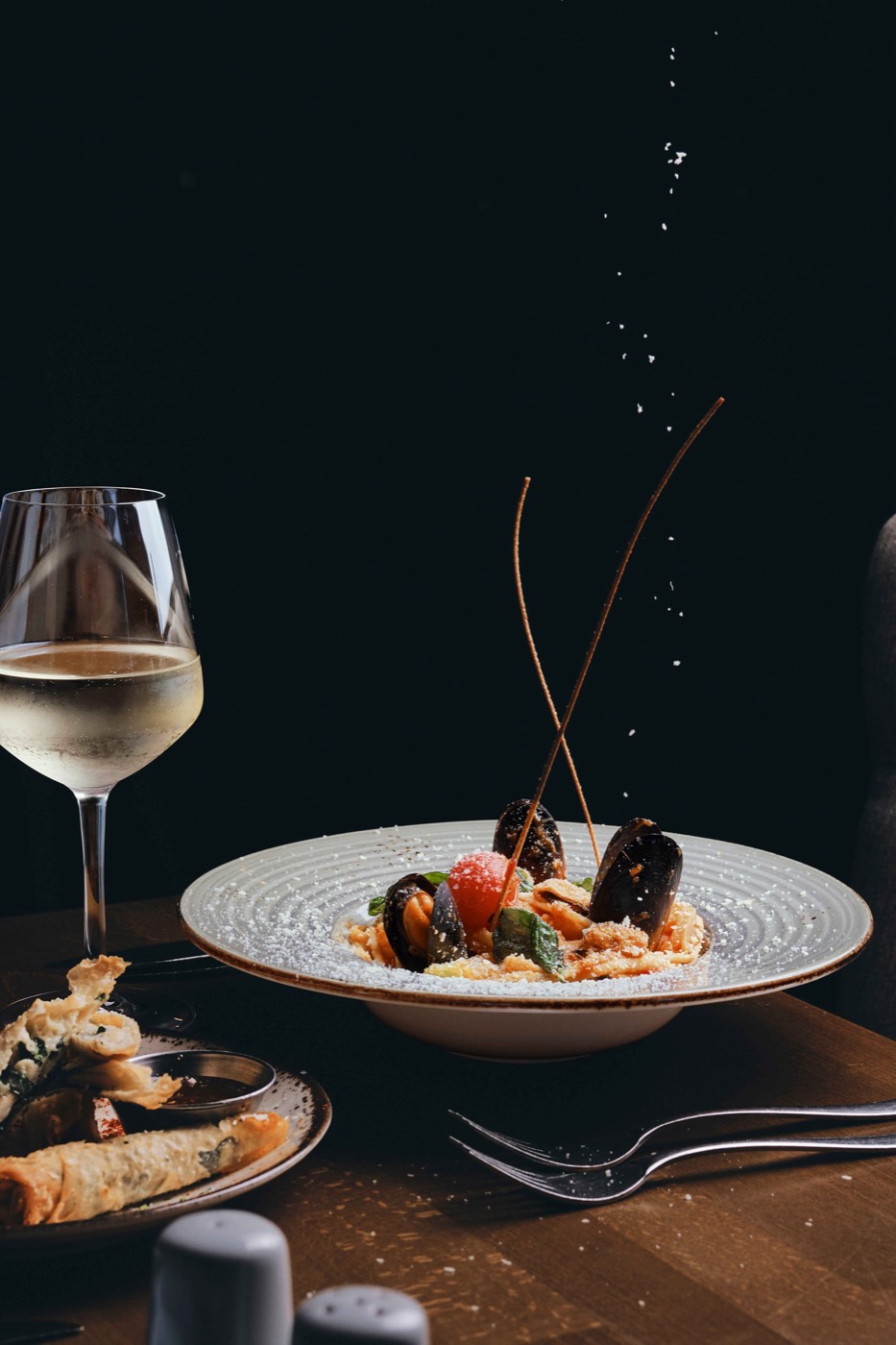 Seafood linguine and a glass of white wine in the dining room